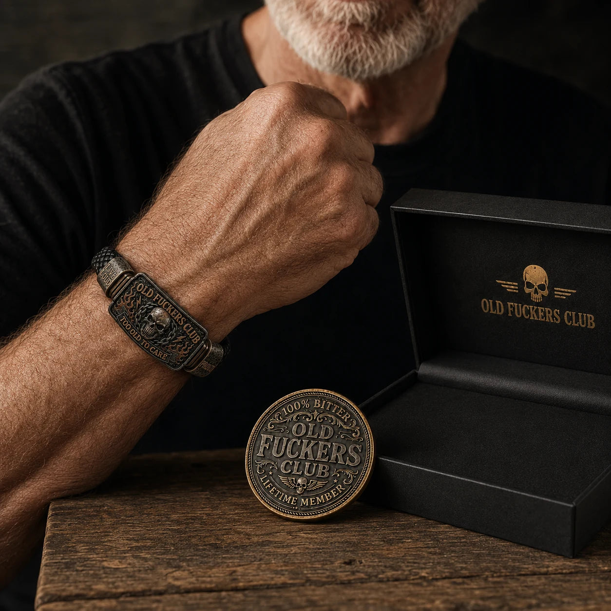 Older man wearing the Old Fuckers Club bracelet beside the collector coin and gift box